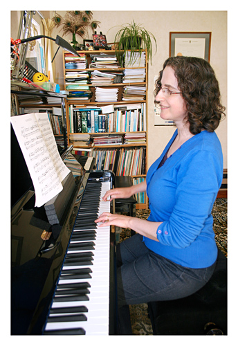 Jane playing the piano in her Studio